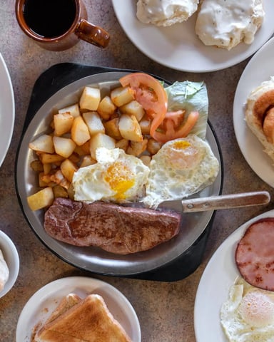 Breakfast spread with eggs, potatoes, and pastries