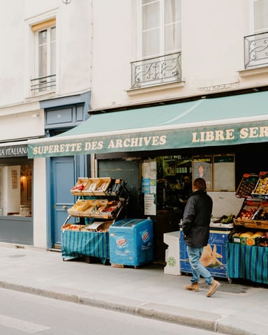 Corner grocery store with fresh fruit stands on the street