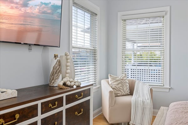 Coastal bedroom with dresser and armchair