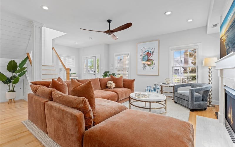 Rust sectional sofa with large artwork and fireplace